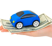Hand with money and toy car