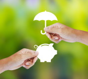 Hand holding a paper  piggy bank and umbrella, Insurance concept