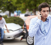 Teenage Driver Making Phone Call After Traffic Accident