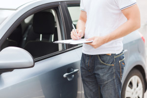 man with car documents